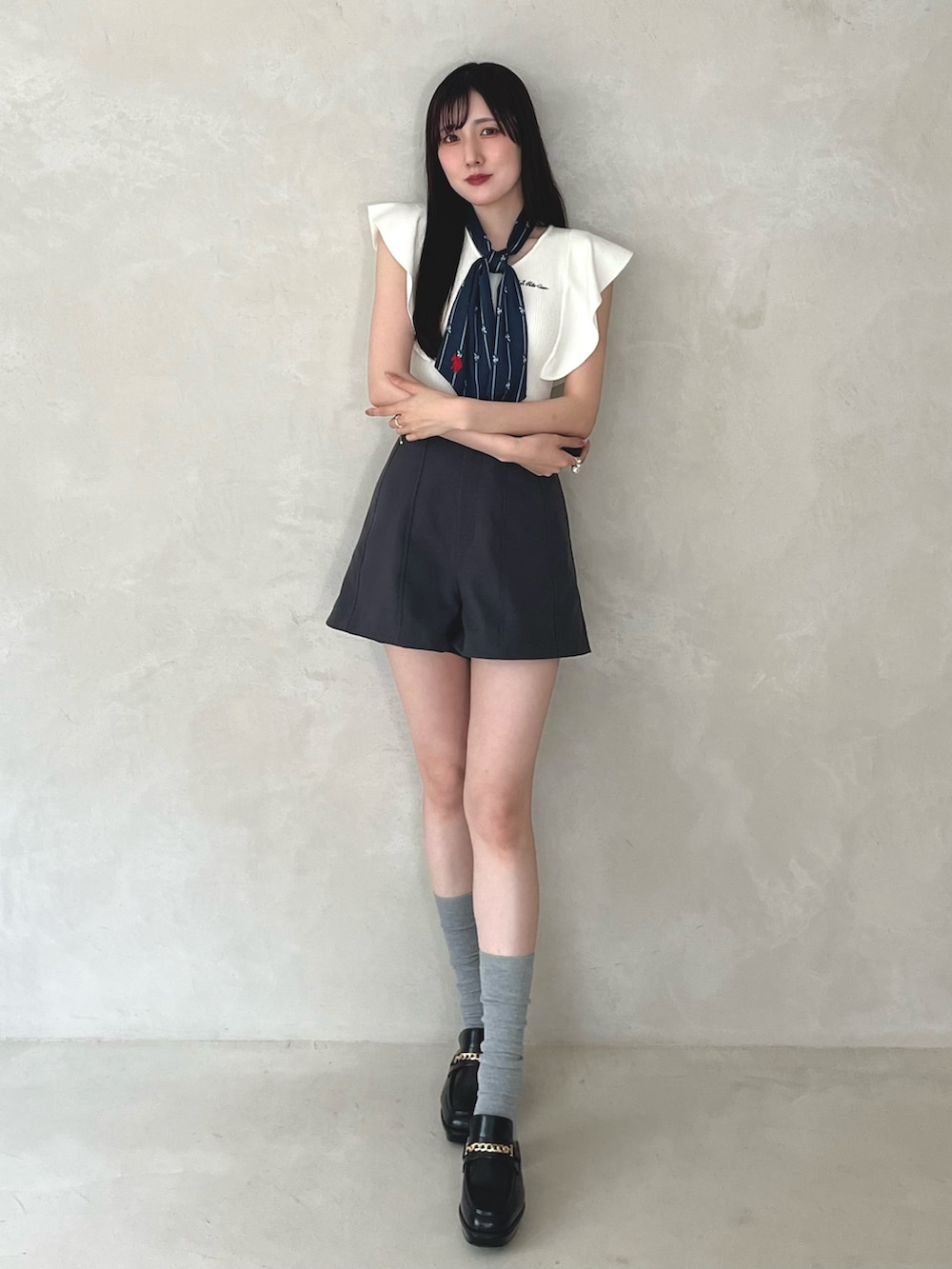 グレー系のその他パンツ、ブラック系のシューズ、ホワイト系のニット/セーターを着用したレディースの夏コーディネートの3枚目の写真