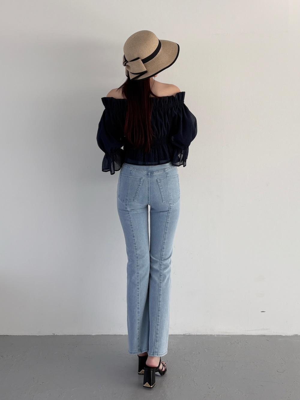 ブルー系のデニムパンツ、ブラック系のサンダル、ブルー系のシャツ/ブラウスを着用したレディースの春コーディネートの3枚目の写真