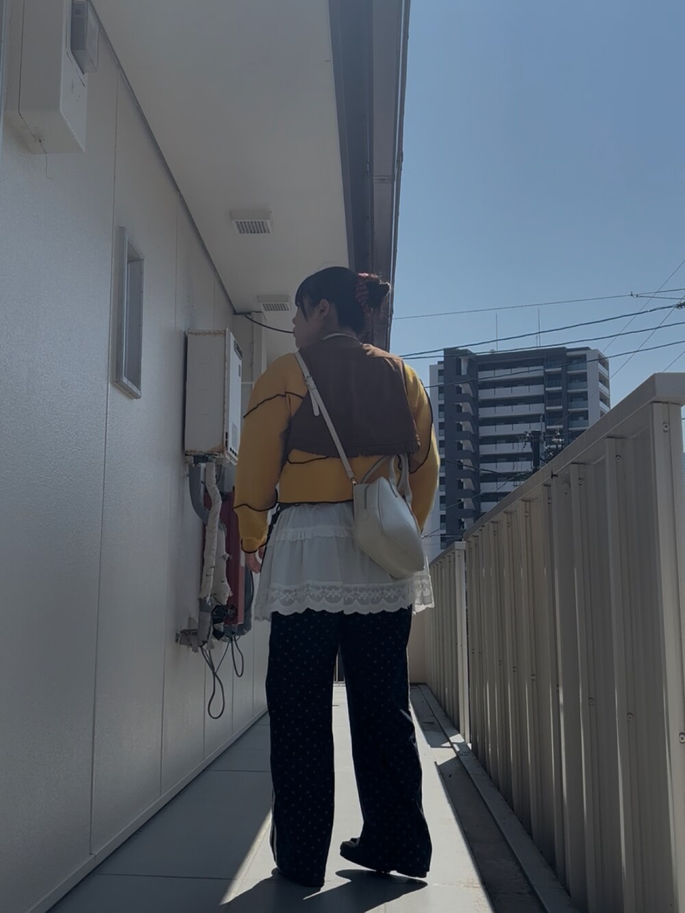ブルー系のスウェットパンツ、ホワイト系のキャミソール、イエロー系のスウェットを着用したレディースの春コーディネートの2枚目の写真