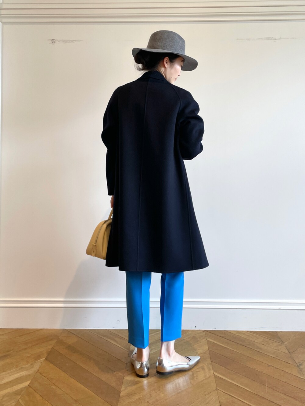 ホワイト系のTシャツ/カットソー、ブルー系のチェスターコート、イエロー系のボストンバッグを着用したレディースの秋コーディネートの2枚目の写真