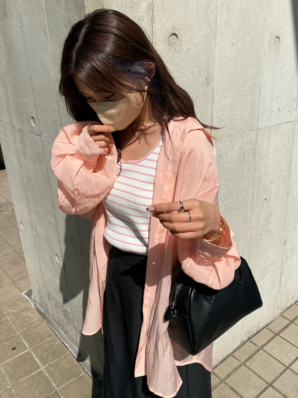 ベージュ系のスニーカー、ブラック系のスカート、ピンク系のシャツ/ブラウスを着用したレディースの夏コーディネートの2枚目の写真