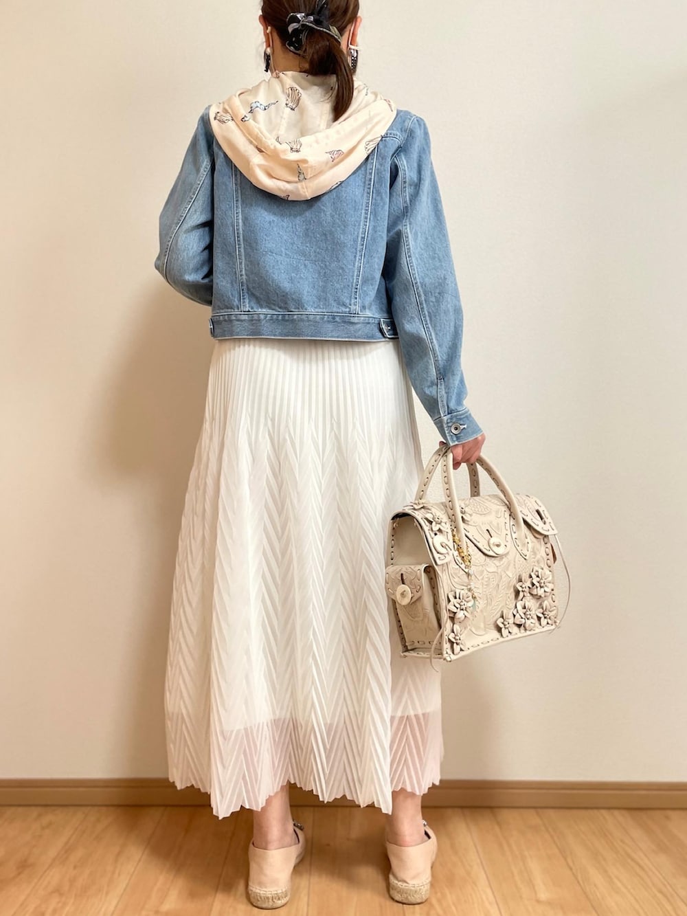 ホワイト系のスカート、ベージュ系のスリッポン、ホワイト系のハンドバッグを着用したレディースの春コーディネートの2枚目の写真