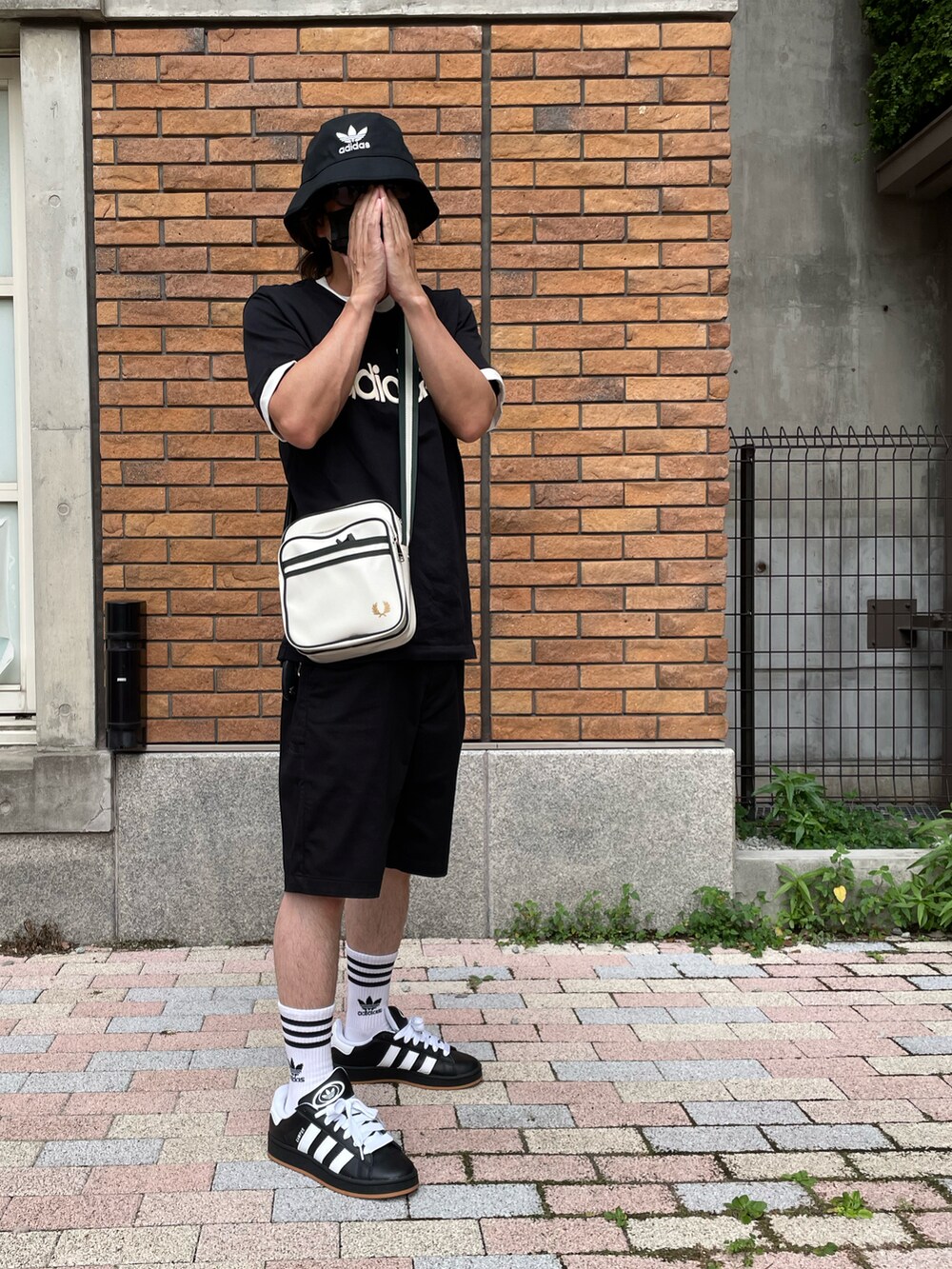 ブラック系のTシャツ/カットソー、ブラック系のその他パンツ、ホワイト系のショルダーバッグを着用したメンズの夏コーディネートの3枚目の写真