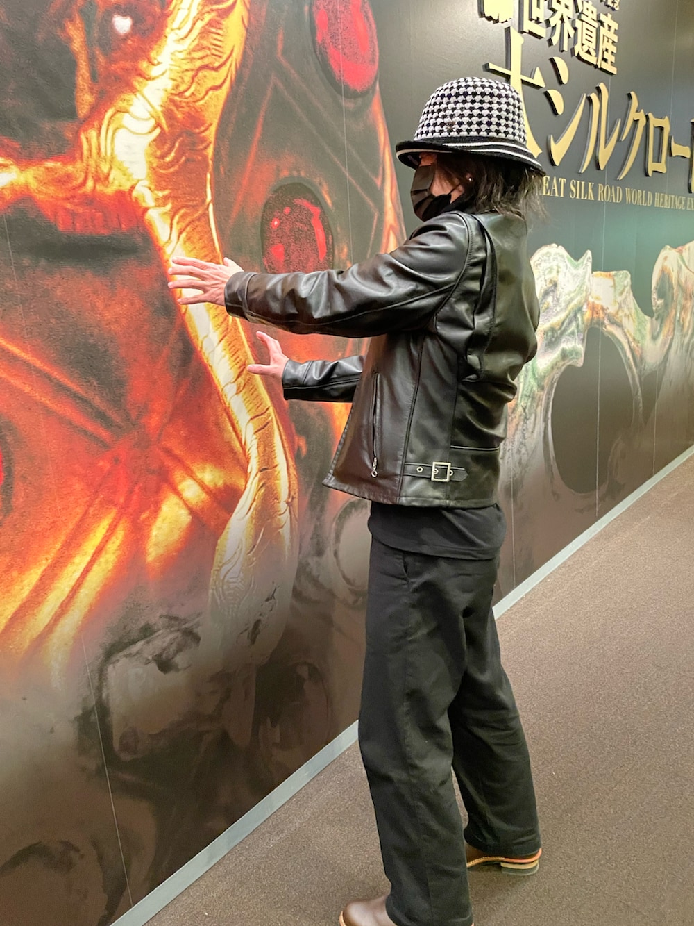 ブラック系のライダースジャケット、ブラック系のチノパンツ、ブラック系のポロシャツを着用したメンズの冬コーディネートの4枚目の写真
