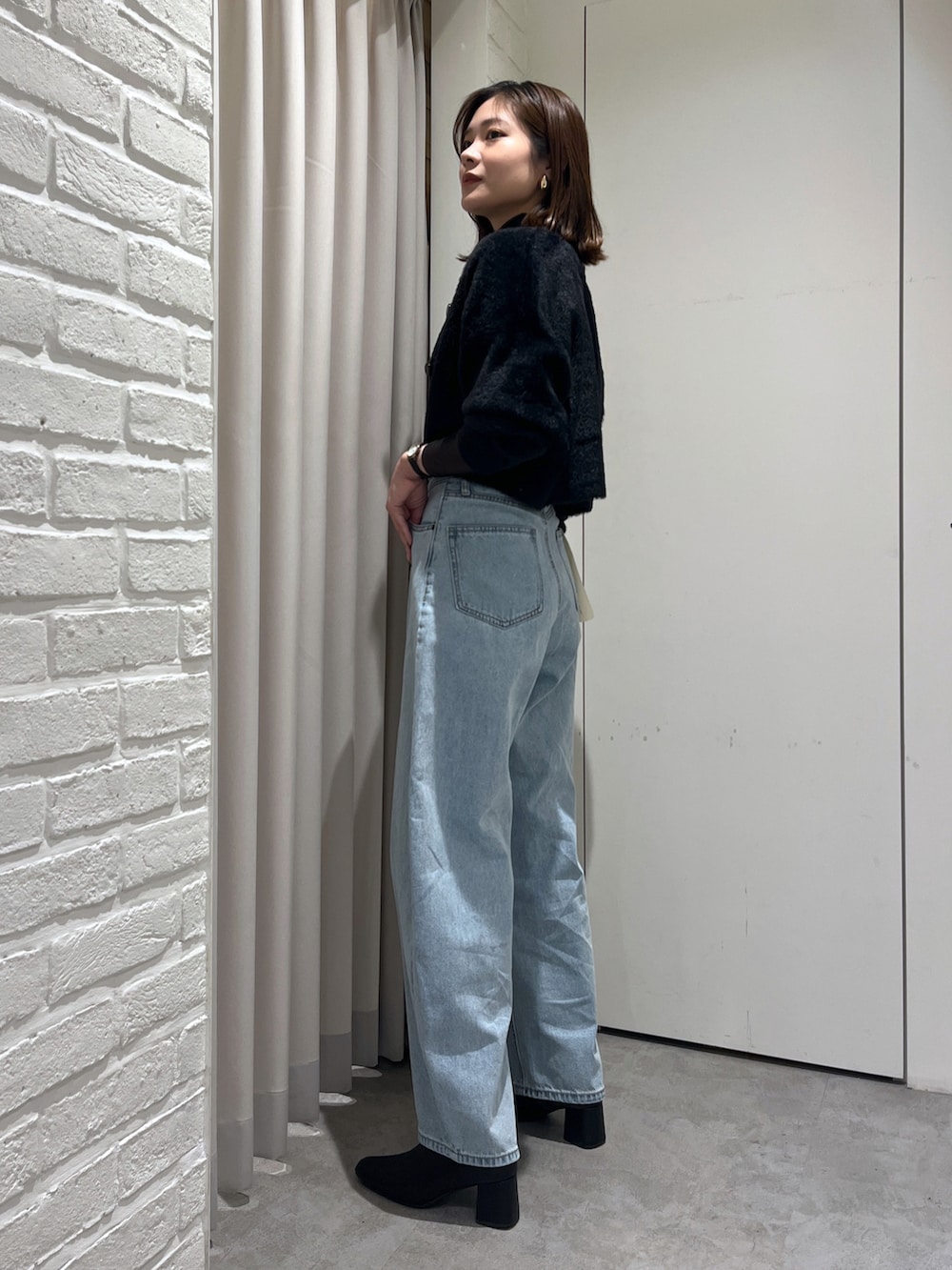ブラック系のニット/セーター、ブラック系のキャミソール、ブラック系のTシャツ/カットソーを着用したレディースの秋コーディネートの2枚目の写真