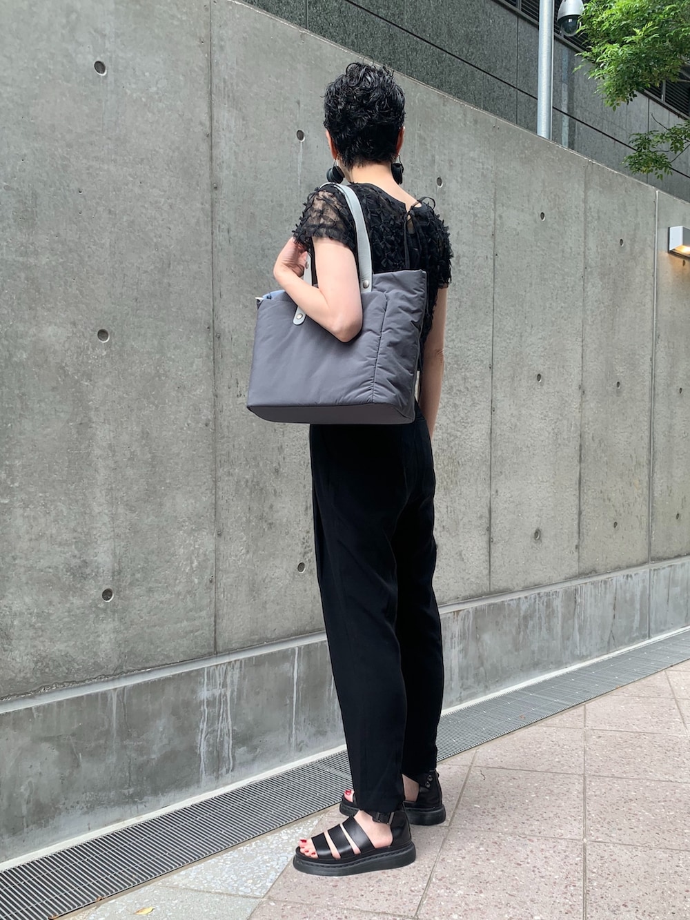 グレー系のトートバッグを着用したレディースの夏コーディネートの4枚目の写真