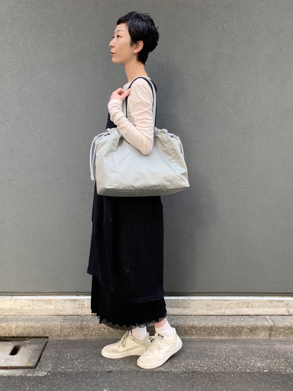 グリーン系のトートバッグを着用したレディースの春コーディネートの4枚目の写真