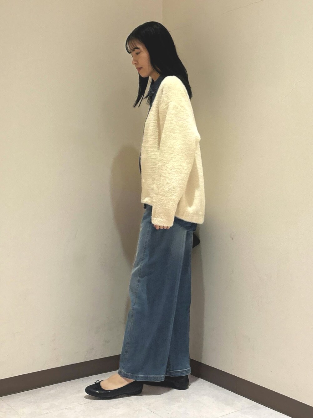 ブルー系のシャツ/ブラウス、ホワイト系のカーディガン/ボレロ、ブルー系のデニムパンツを着用したレディースの秋コーディネートの2枚目の写真