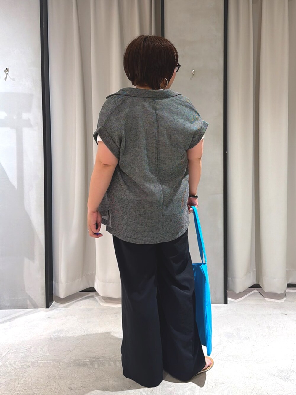 ブラック系のその他アウター、ブルー系のトートバッグ、ブラック系のその他パンツを着用したレディースの夏コーディネートの3枚目の写真