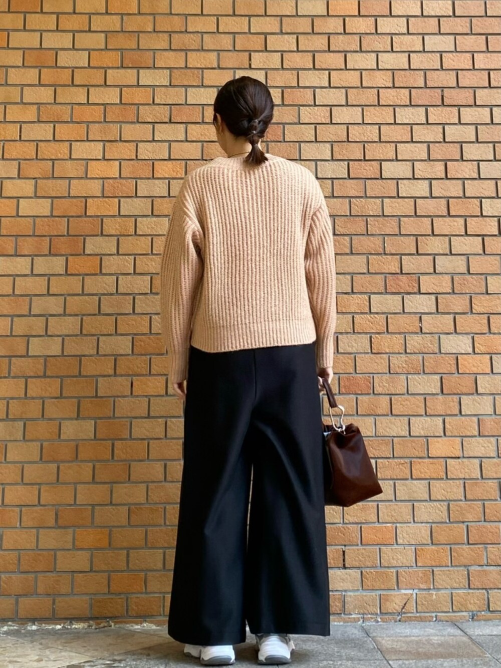 ピンク系のニット/セーター、ブラック系のその他パンツを着用したレディースの冬コーディネートの4枚目の写真