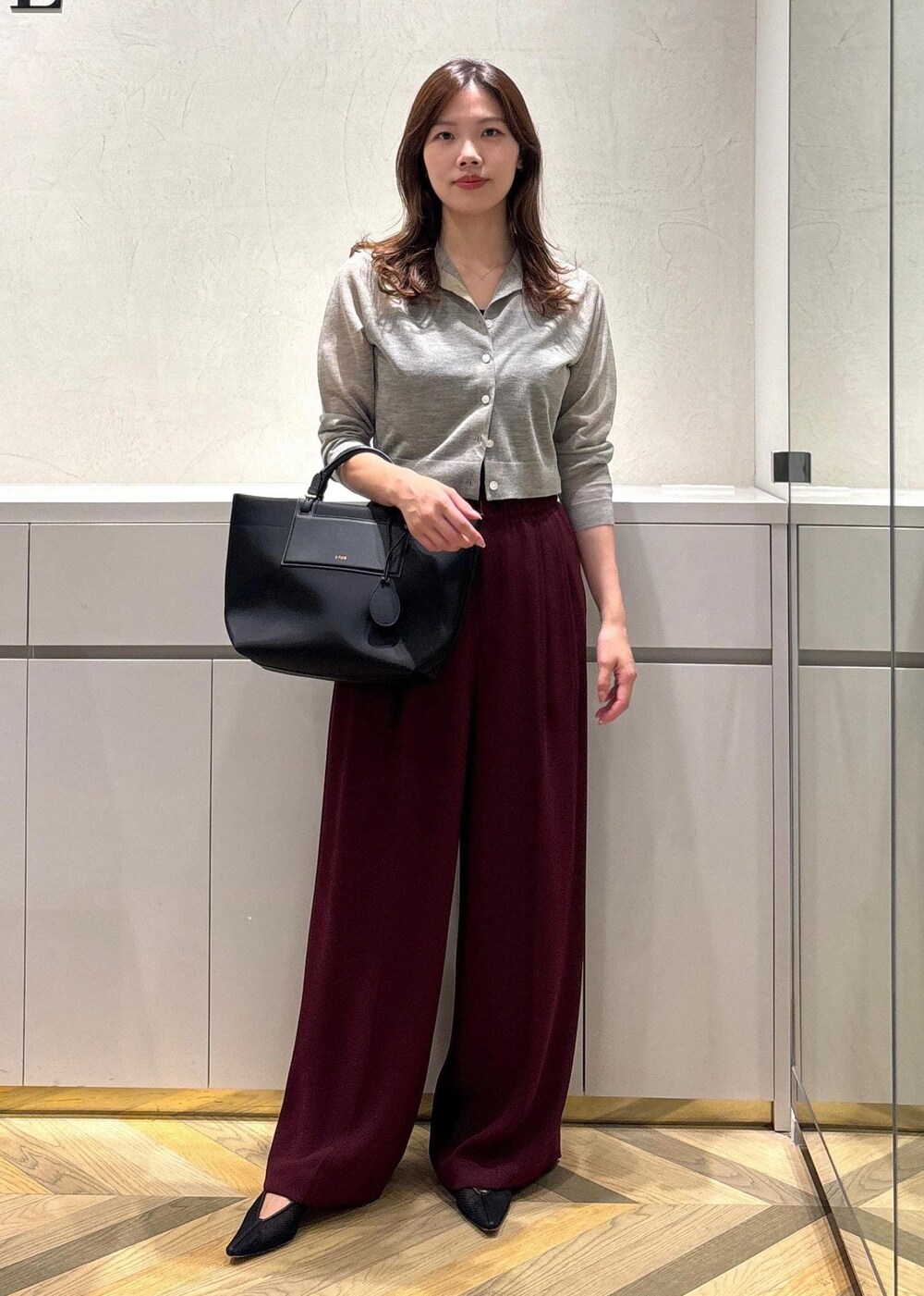 ブラック系のパンプス、レッド系のその他パンツ、ベージュ系のカーディガン/ボレロを着用したレディースの夏コーディネートの2枚目の写真