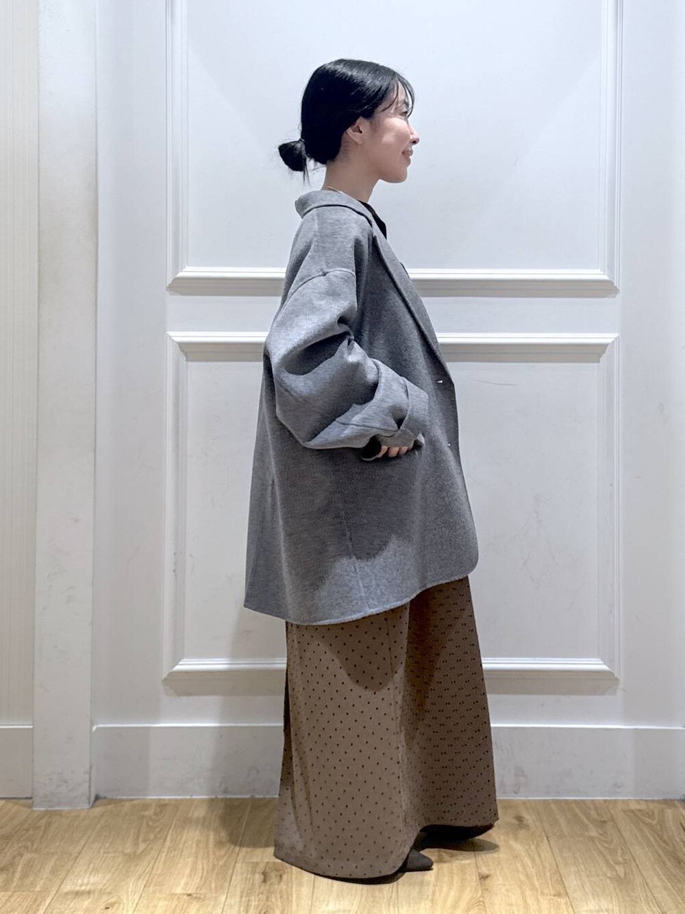 グレー系のテーラードジャケット、ブラウン系のパンプス、ブラック系のTシャツ/カットソーを着用したレディースの秋コーディネートの4枚目の写真