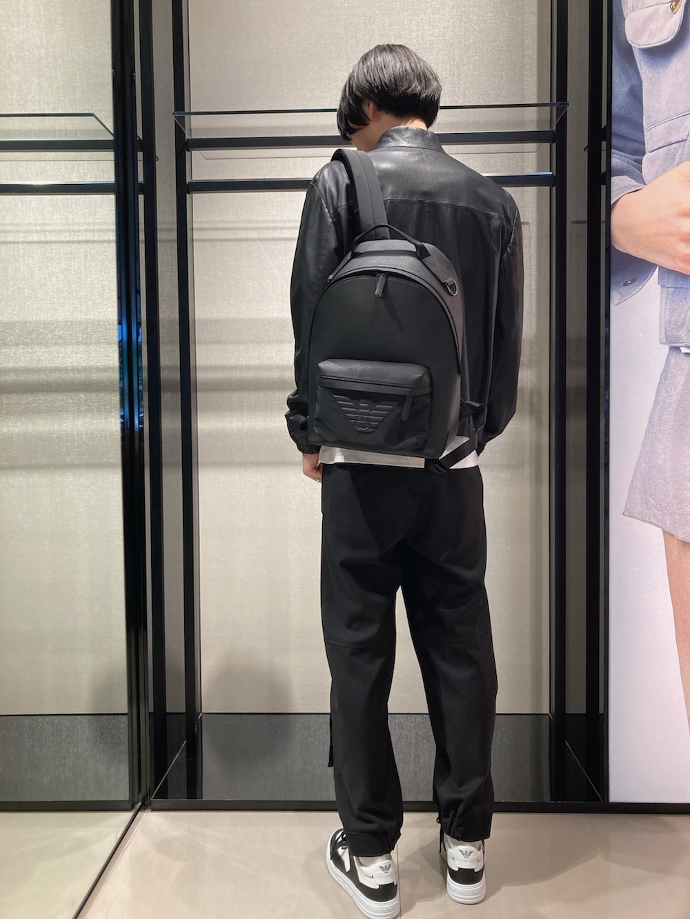 ホワイト系のTシャツ/カットソー、ブラック系のライダースジャケット、ブラック系のバックパック/リュックを着用したメンズの春コーディネートの3枚目の写真