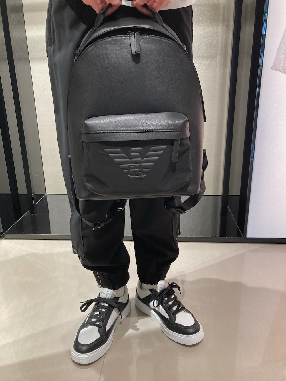 ホワイト系のTシャツ/カットソー、ブラック系のライダースジャケット、ブラック系のバックパック/リュックを着用したメンズの春コーディネートの4枚目の写真