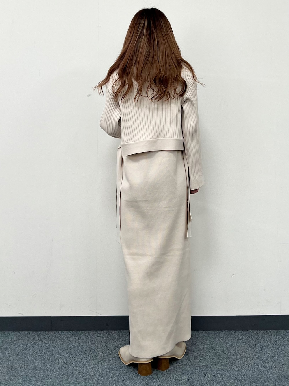 ベージュ系のワンピース、ベージュ系のブーツ、グリーン系のストール/ショールを着用したレディースの冬コーディネートの3枚目の写真