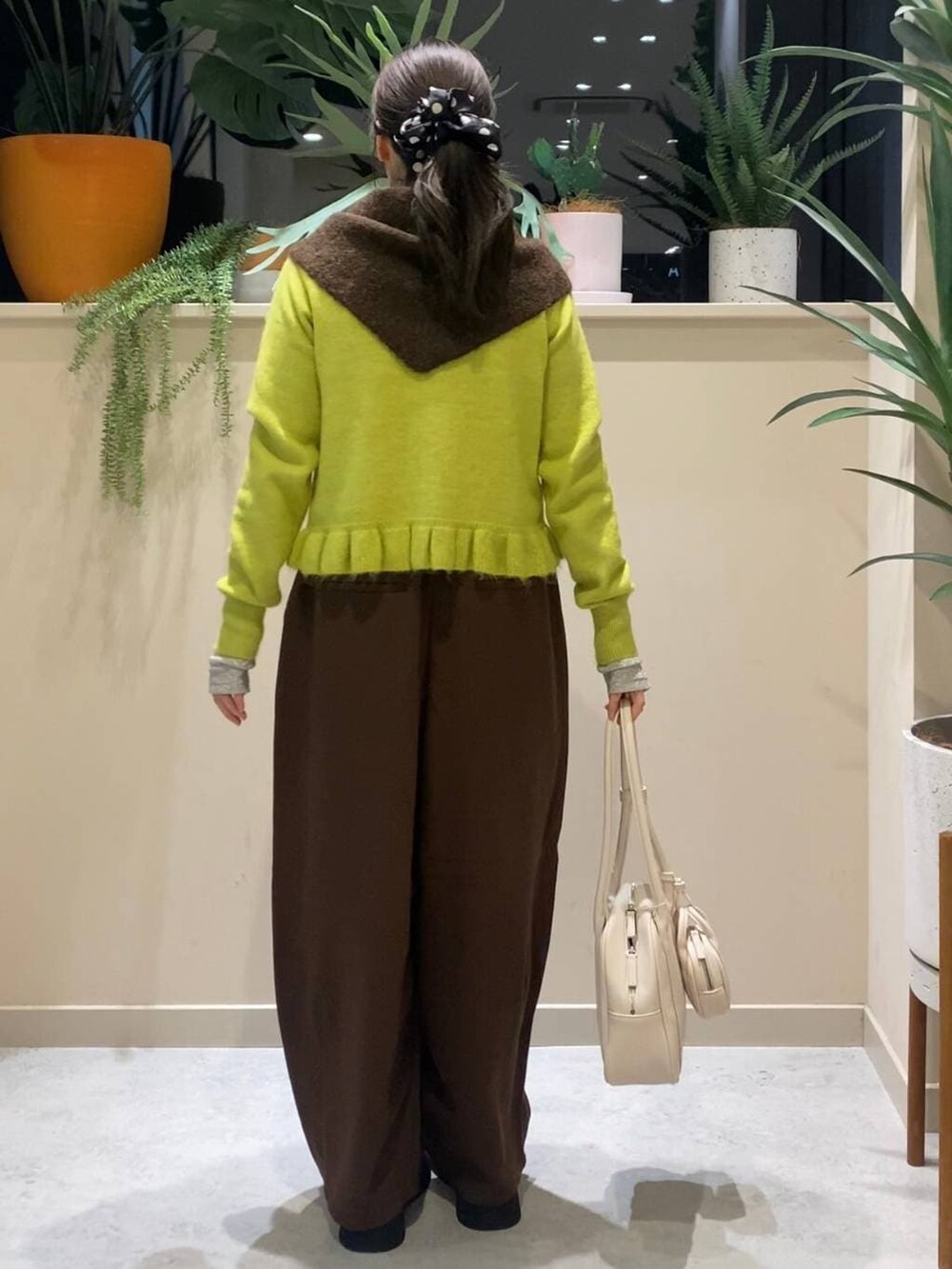ブラウン系のその他パンツ、ブラック系のサンダル、イエロー系のニット/セーターを着用したレディースの冬コーディネートの3枚目の写真