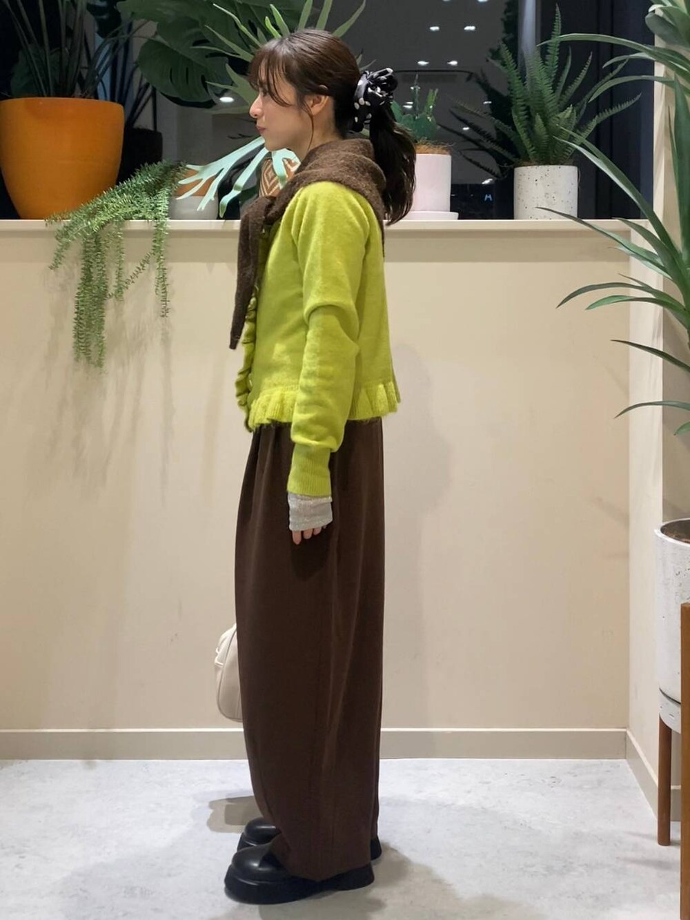 ブラウン系のその他パンツ、ブラック系のサンダル、イエロー系のニット/セーターを着用したレディースの冬コーディネートの4枚目の写真
