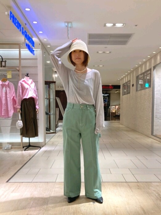 グレー系のTシャツ/カットソー、グリーン系のその他パンツ、ホワイト系のハットを着用したレディースの春コーディネートの2枚目の写真