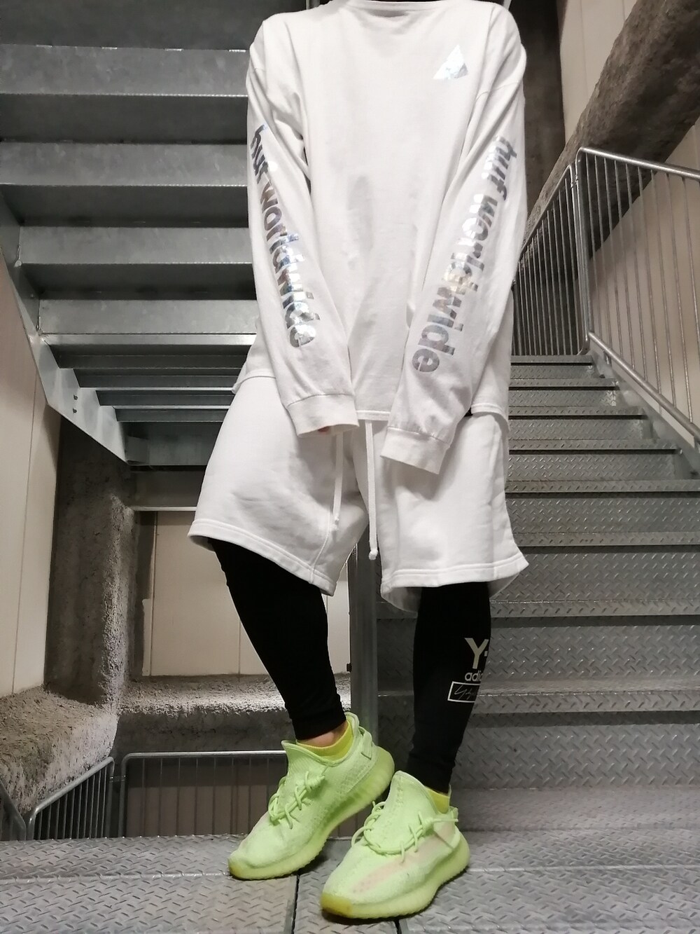 グリーン系のスニーカー、ホワイト系のパンツ、ホワイト系のトップスを着用したメンズの春コーディネートの4枚目の写真