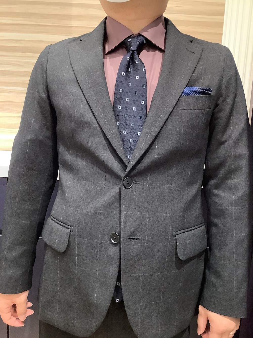 ブルー系のネクタイ、レッド系のビジネスシャツを着用したメンズの冬コーディネートの2枚目の写真