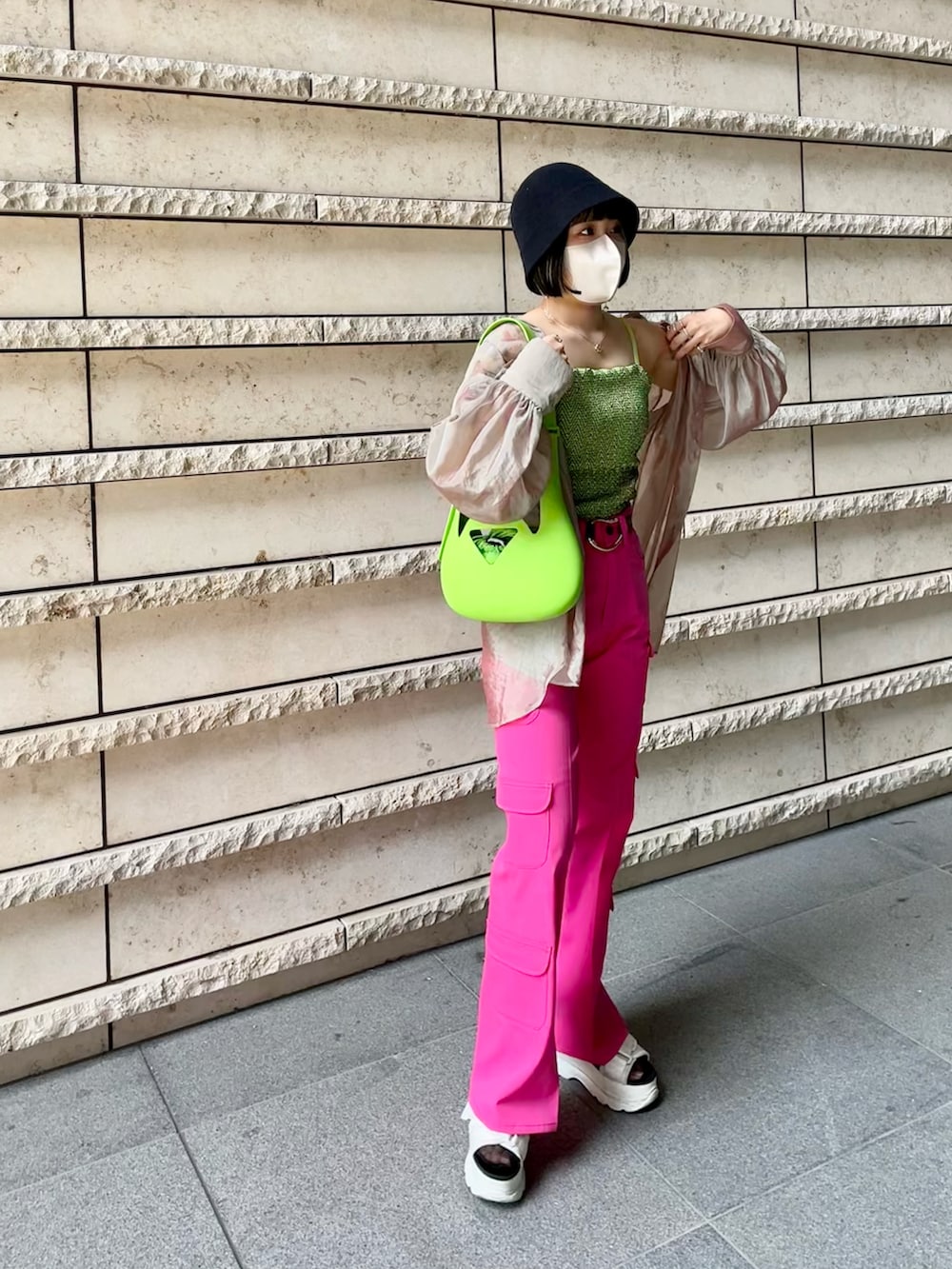 ホワイト系のサンダル、ピンク系のカーゴパンツ、グリーン系のキャミソールを着用したレディースの夏コーディネートの2枚目の写真