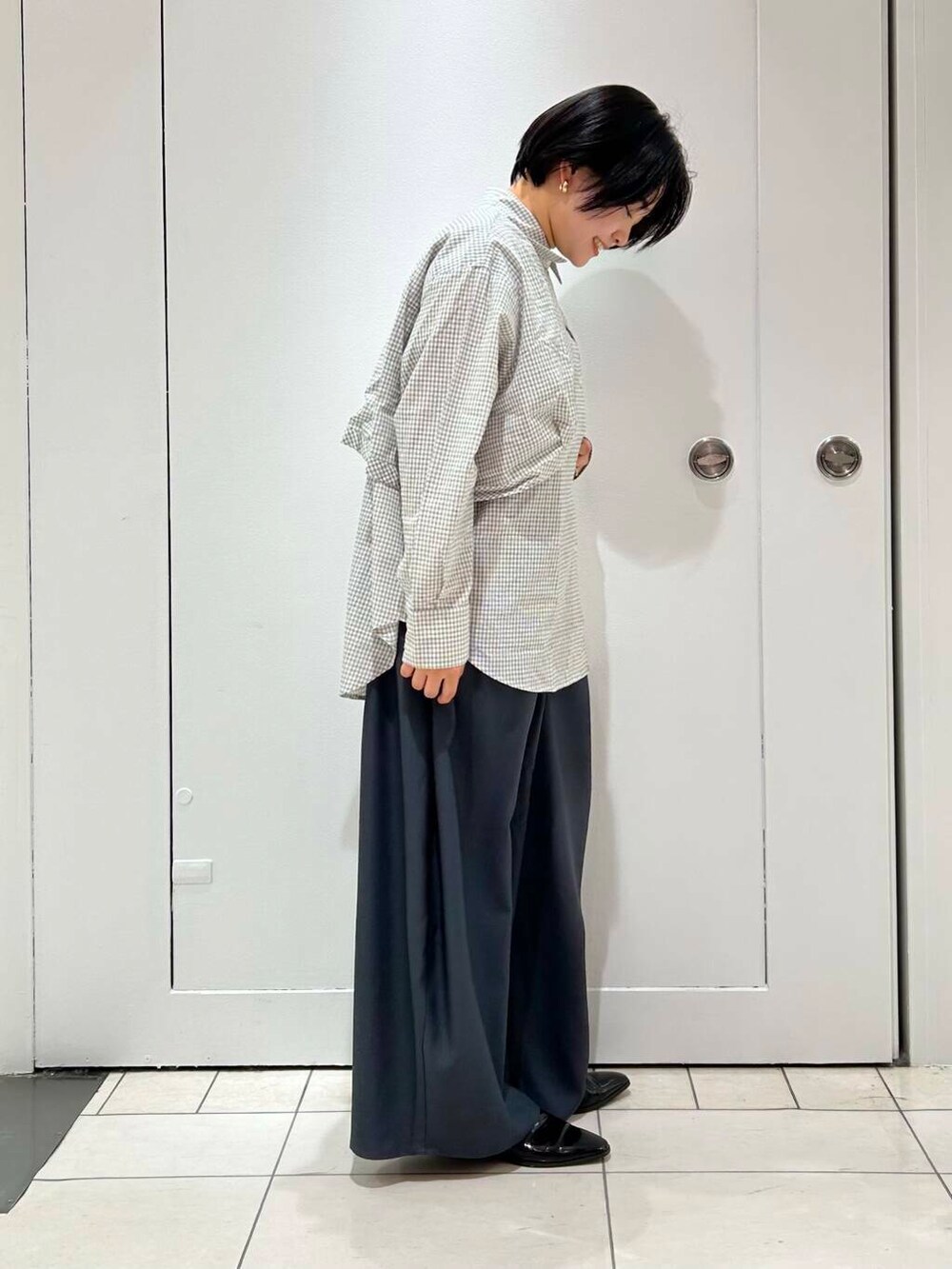 グレー系のその他パンツ、ホワイト系のシャツ/ブラウスを着用したレディースの冬コーディネートの3枚目の写真