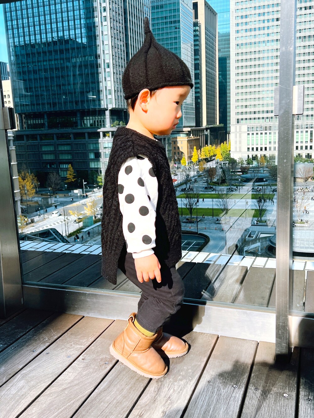 ホワイト系のTシャツ/カットソー、ブラック系のベスト、ブラック系のニットキャップ/ビーニーを着用したキッズの冬コーディネートの2枚目の写真