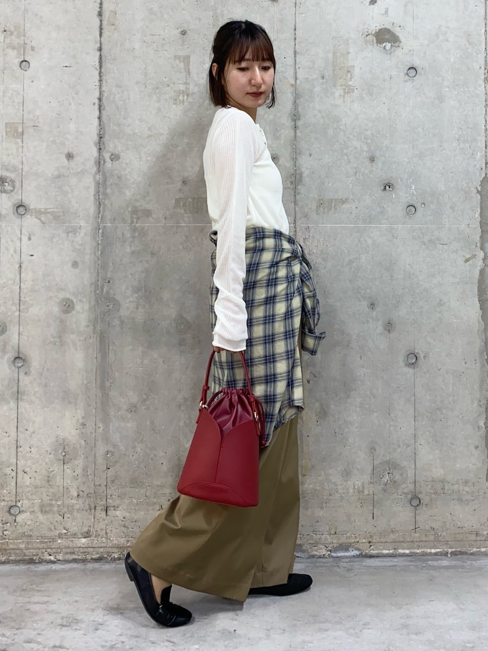 ホワイト系のニット/セーター、イエロー系のシャツ/ブラウス、ベージュ系のその他パンツを着用したレディースの秋コーディネートの2枚目の写真