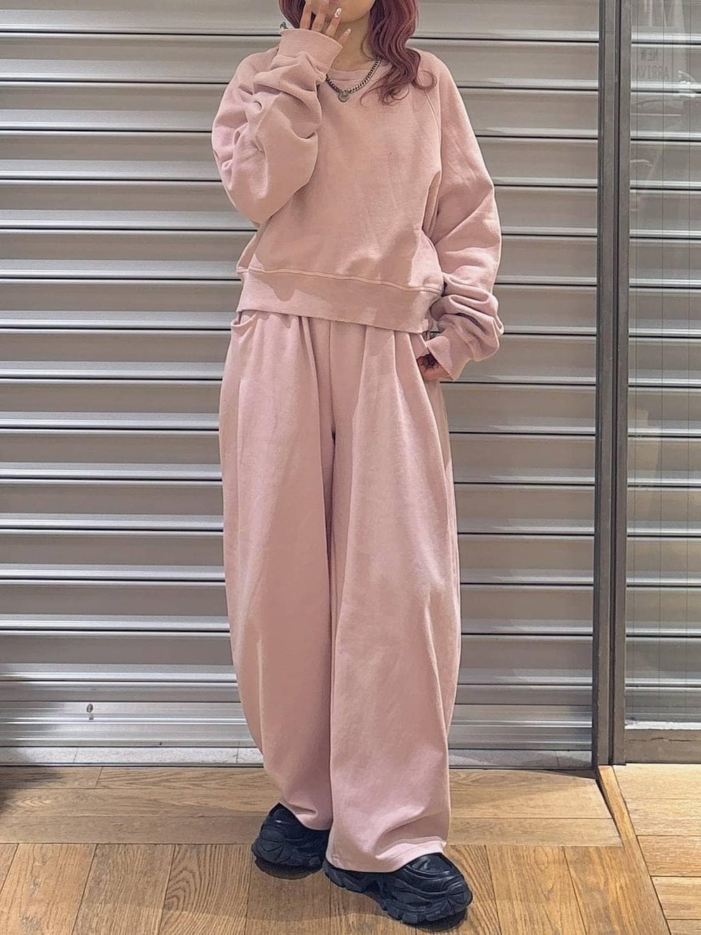 ブラック系のローファー、ピンク系のスウェット、ピンク系のスウェットパンツを着用したレディースの冬コーディネートの2枚目の写真