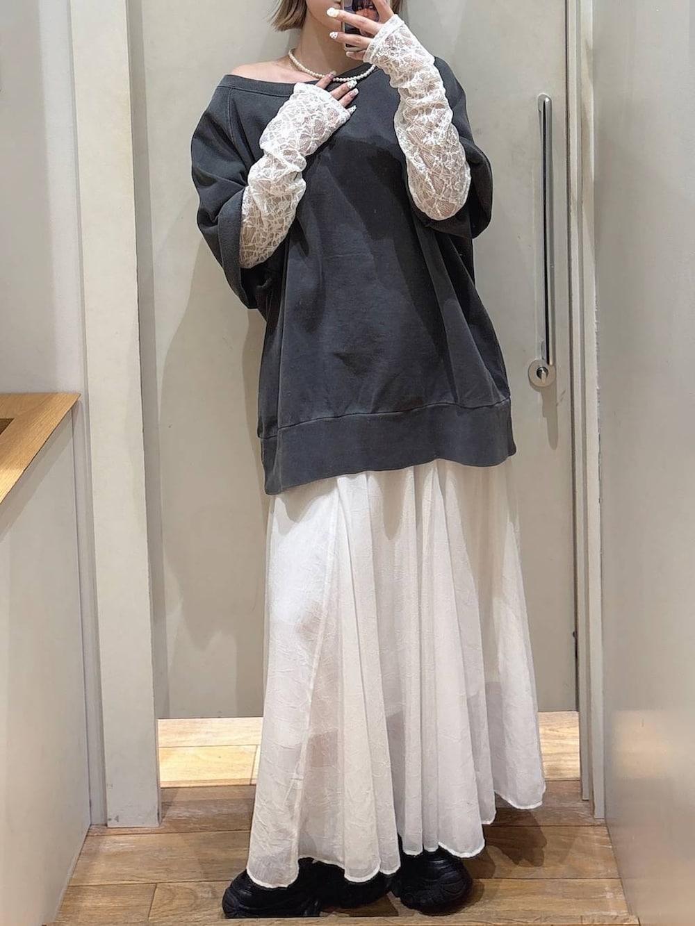 ブラック系のローファー、ホワイト系のTシャツ/カットソー、ホワイト系のスカートを着用したレディースの春コーディネートの2枚目の写真