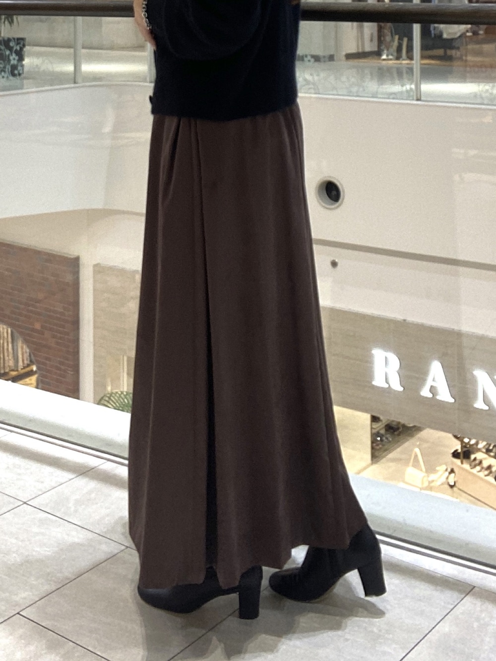 ホワイト系のその他アウター、ブラウン系のスカート、ブラック系のボストンバッグを着用したレディースの秋コーディネートの8枚目の写真