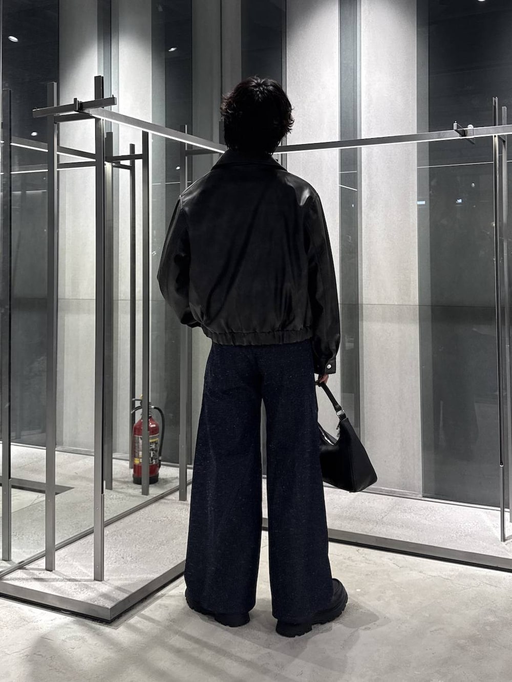ブラック系のローファー、グレー系のTシャツ/カットソー、ブラック系のショルダーバッグを着用したメンズの秋コーディネートの2枚目の写真
