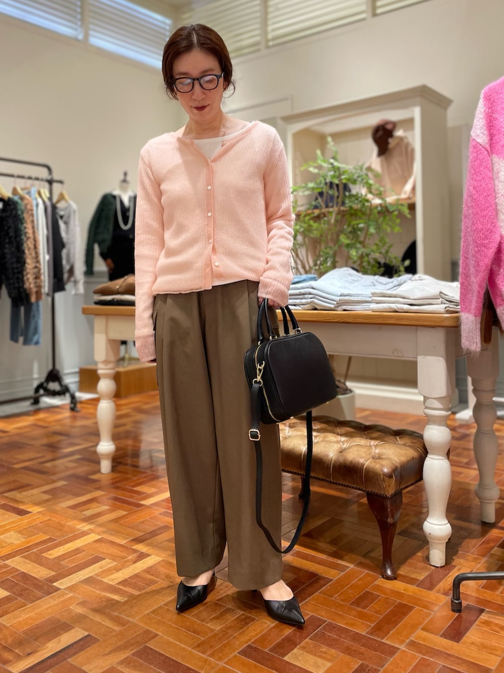 ピンク系のカーディガン/ボレロ、ホワイト系のTシャツ/カットソー、ブラック系のボストンバッグを着用したレディースの秋コーディネートの5枚目の写真