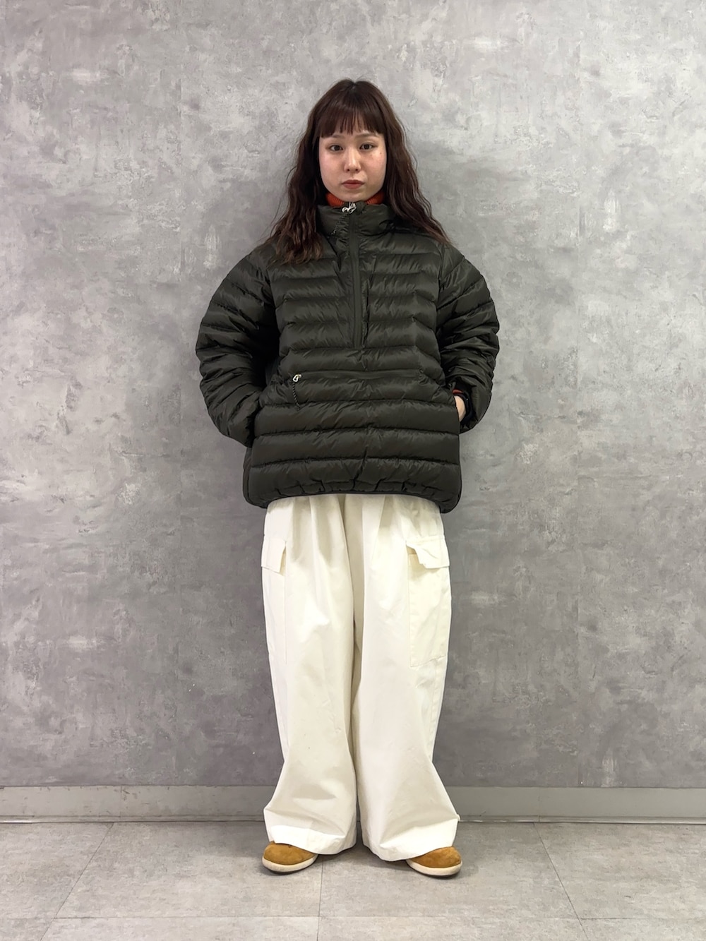 ホワイト系のその他パンツ、オレンジ系のニット/セーター、グリーン系のその他アウターを着用したレディースの冬コーディネートの2枚目の写真