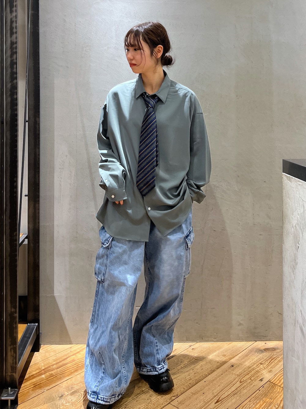 ブルー系のデニムパンツ、グリーン系のシャツ/ブラウスを着用したレディースの春コーディネートの2枚目の写真