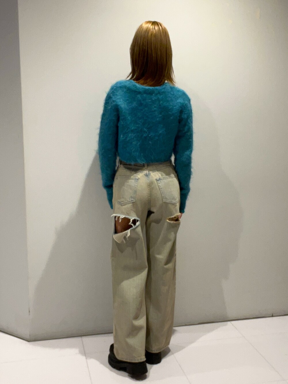 ブルー系のニット/セーター、ブルー系のデニムパンツ、ブラック系のローファーを着用したレディースの秋コーディネートの3枚目の写真