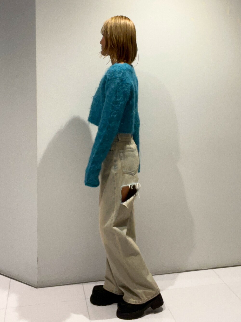 ブルー系のニット/セーター、ブルー系のデニムパンツ、ブラック系のローファーを着用したレディースの秋コーディネートの2枚目の写真