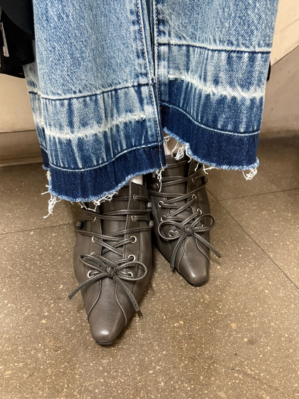 ブラック系のワンピース、ホワイト系のハンドバッグ、ブラック系のサンダルを着用したレディースの春コーディネートの6枚目の写真