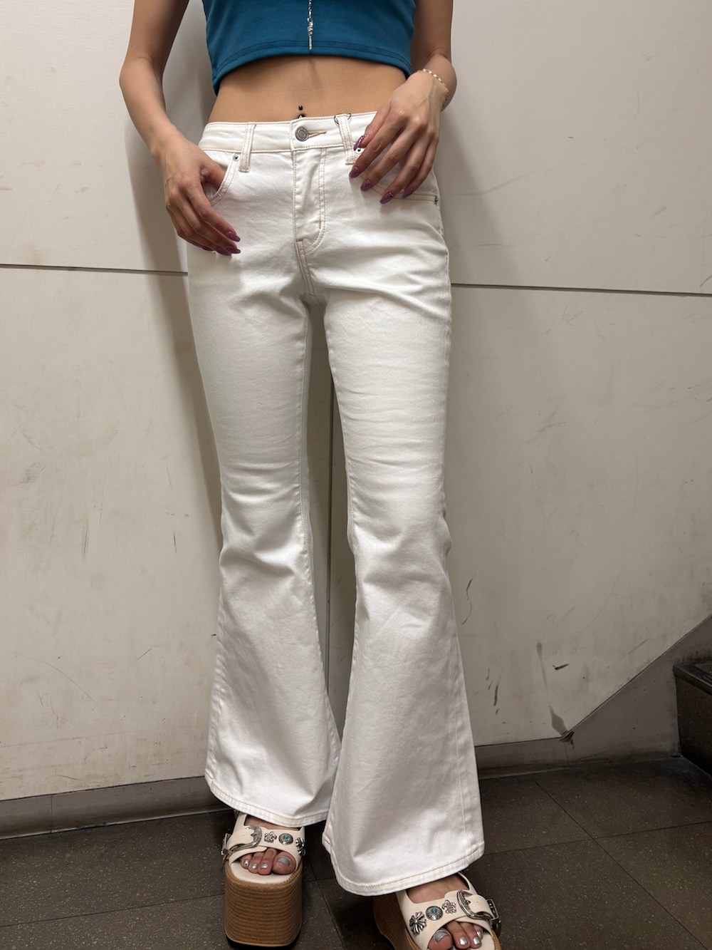 ブルー系のTシャツ/カットソー、ホワイト系のデニムパンツ、ホワイト系のサンダルを着用したレディースの春コーディネートの5枚目の写真