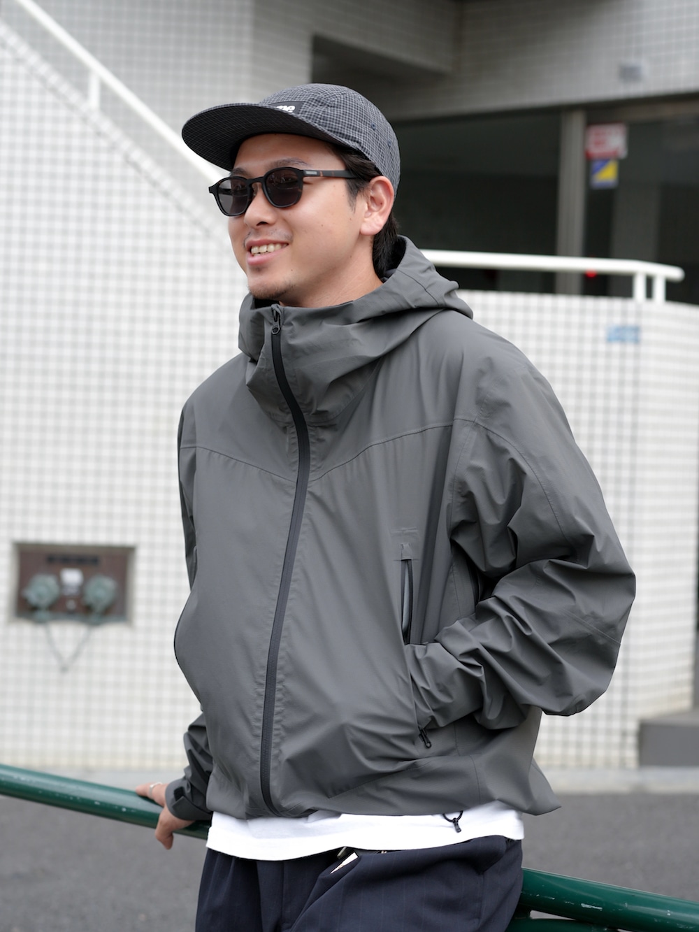 ホワイト系のTシャツ/カットソー、ブラック系のローファー、グレー系のマウンテンパーカーを着用したメンズの秋コーディネートの3枚目の写真