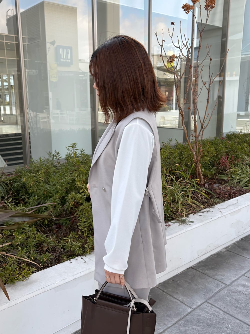 ホワイト系のシャツ/ブラウス、ベージュ系のダウンジャケット/コート、ベージュ系のその他パンツを着用したレディースの冬コーディネートの5枚目の写真