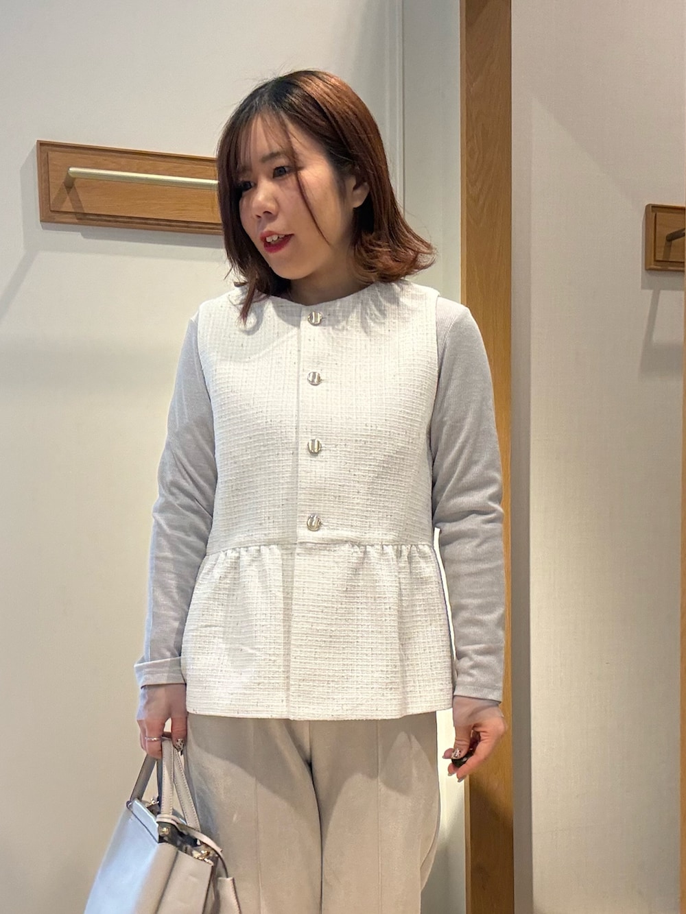 ホワイト系のブルゾン、グレー系のTシャツ/カットソー、ベージュ系のその他パンツを着用したレディースの冬コーディネートの4枚目の写真