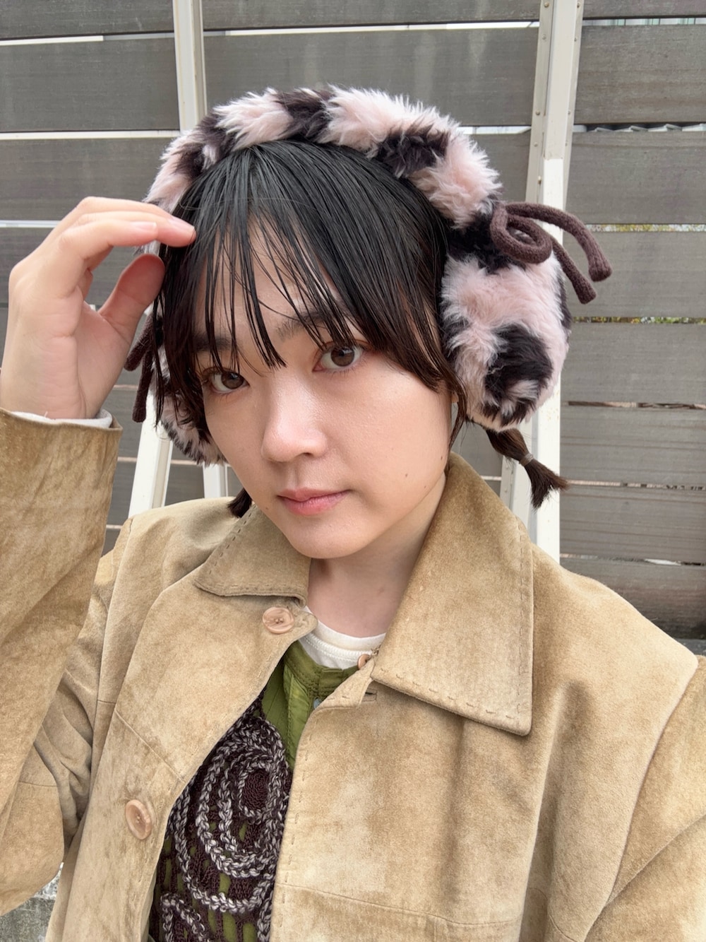 レッド系のスニーカー、ピンク系のイヤーマフを着用したレディースの秋コーディネートの2枚目の写真