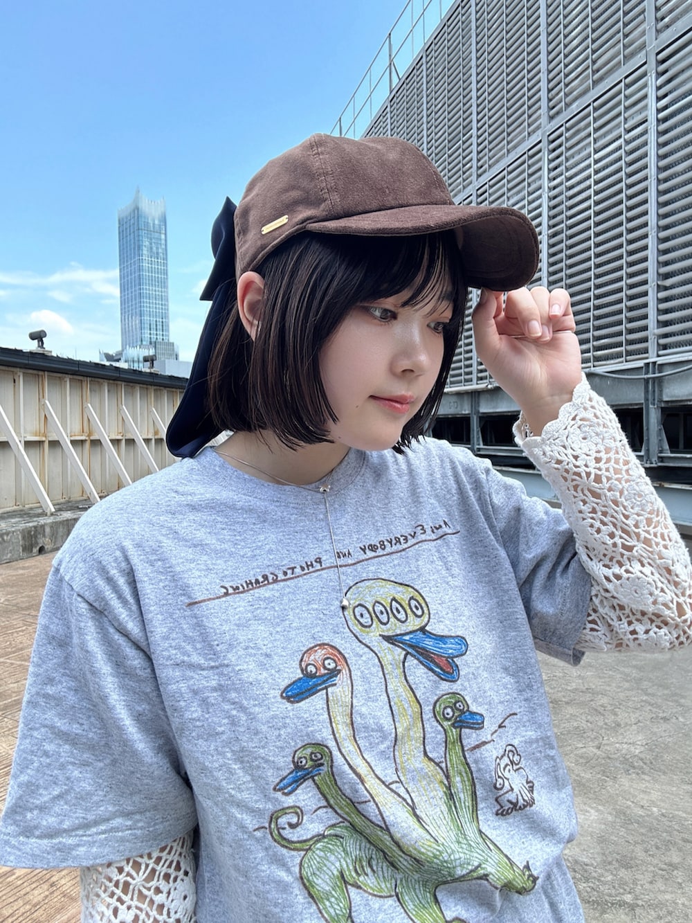 レッド系のスニーカー、ブラウン系のキャップを着用したレディースの夏コーディネートの2枚目の写真