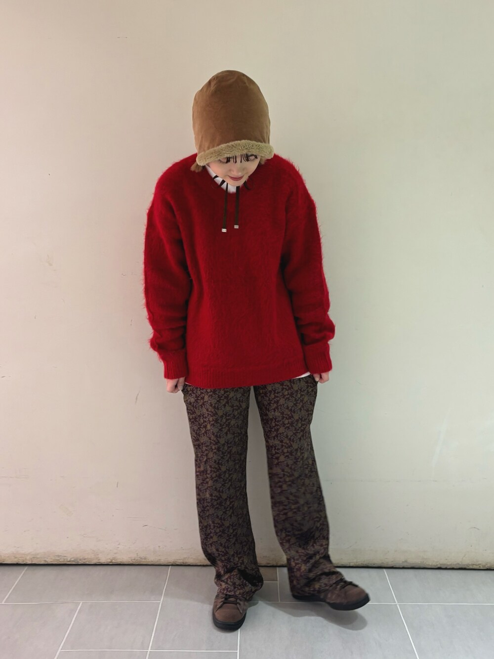 レッド系のニット/セーター、ホワイト系のTシャツ/カットソー、ブラウン系のその他パンツを着用したレディースの秋コーディネートの3枚目の写真