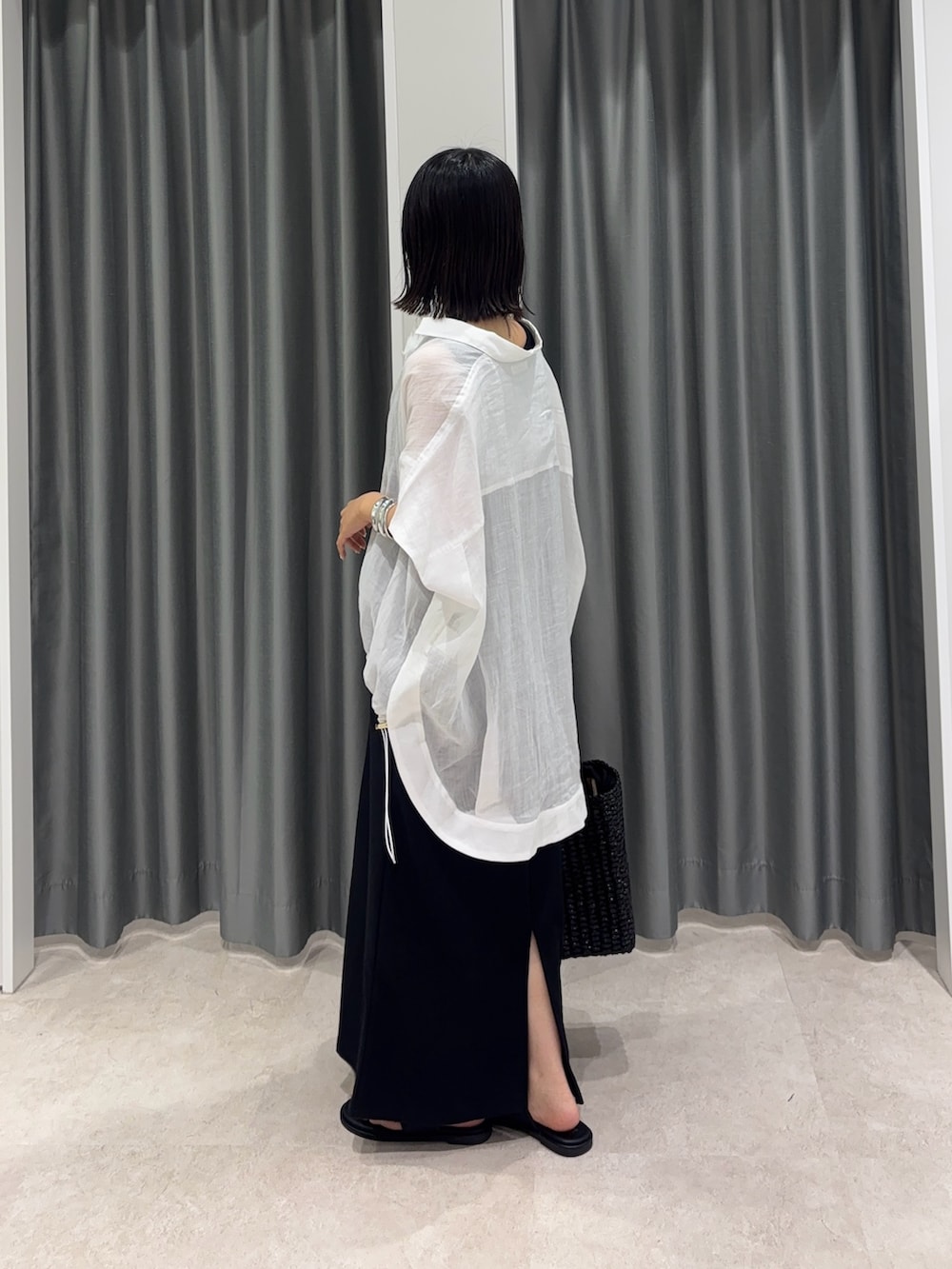 ホワイト系のシャツ/ブラウス、ブラック系のワンピース、ブラック系のトートバッグを着用したレディースの夏コーディネートの3枚目の写真