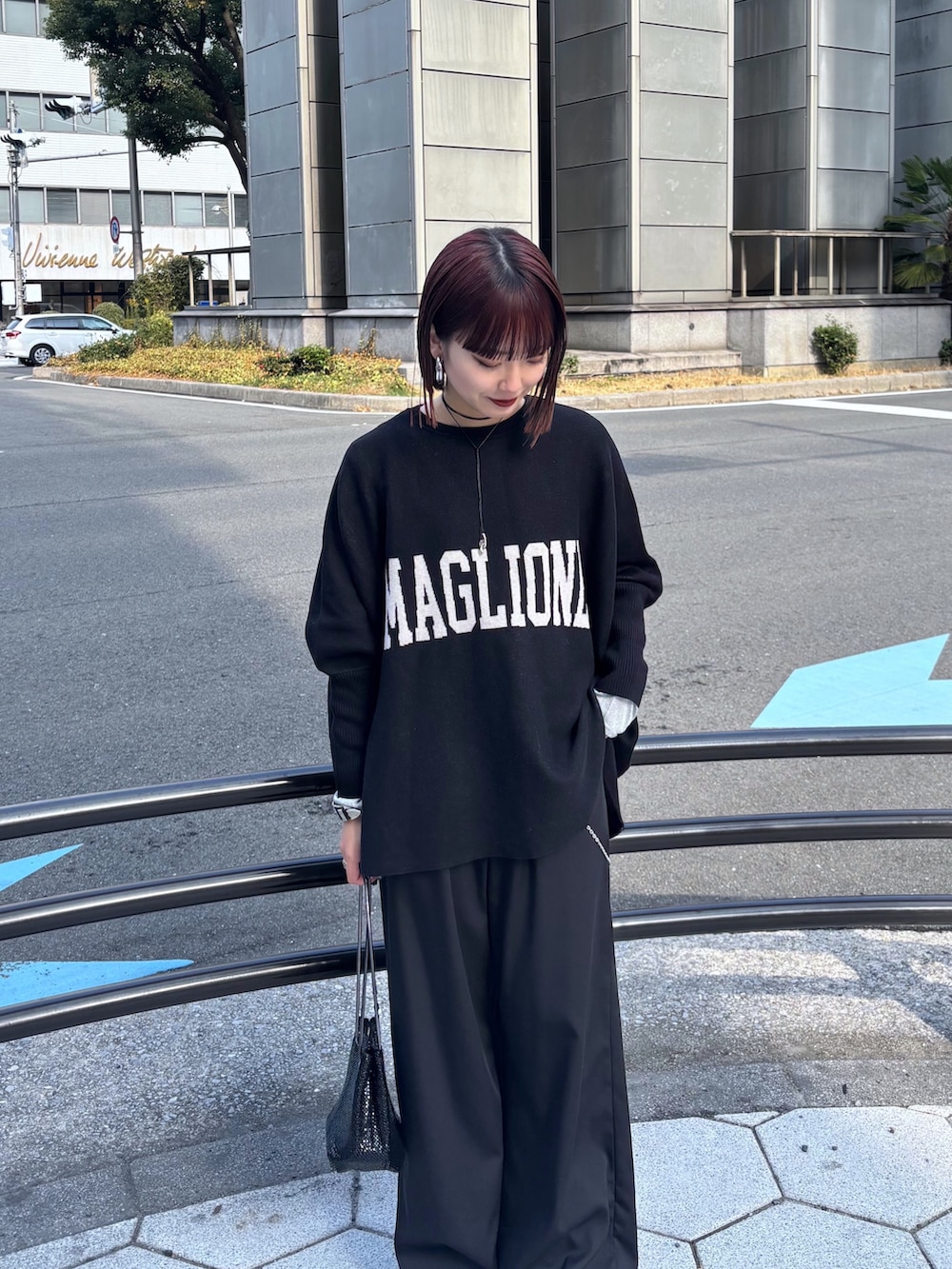 ブラック系のニット/セーター、ブラック系のその他パンツ、ブラック系のショルダーバッグを着用したレディースの冬コーディネートの6枚目の写真