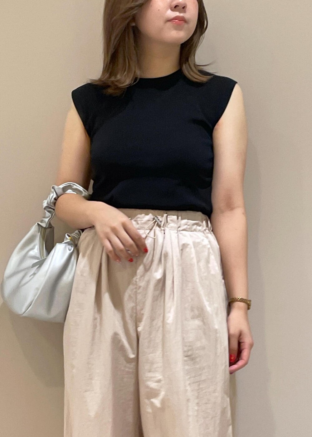 ブラック系のニット/セーター、シルバー系のハンドバッグ、ピンク系のその他パンツを着用したレディースの夏コーディネートの4枚目の写真