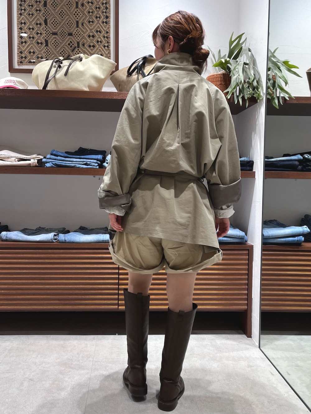 グリーン系のトレンチコート、ベージュ系のその他パンツを着用したレディースの春コーディネートの4枚目の写真