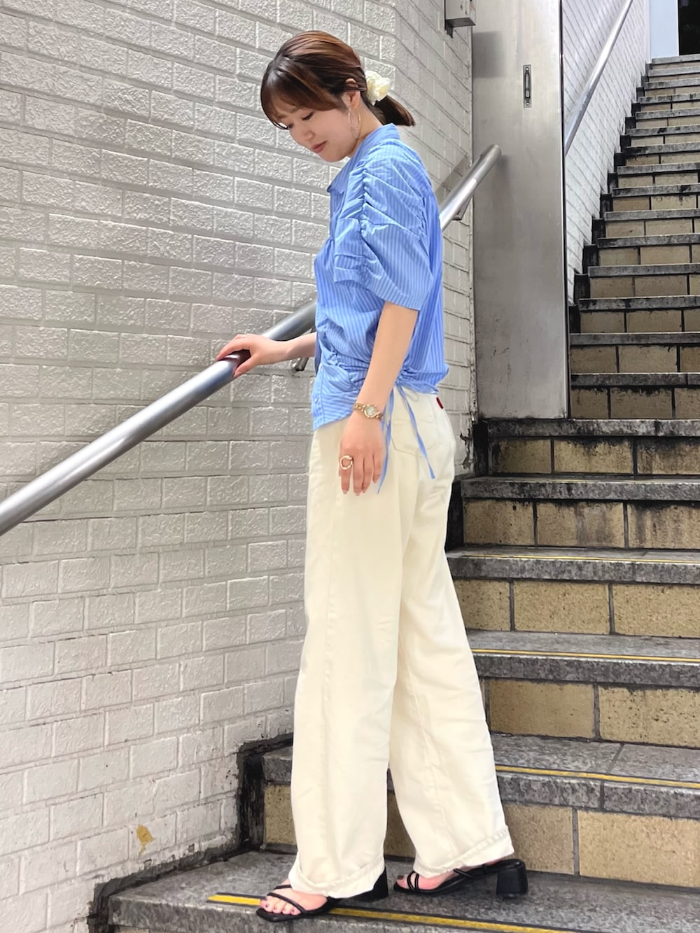 ブルー系のシャツ/ブラウス、ホワイト系のデニムパンツを着用したレディースの春コーディネートの3枚目の写真